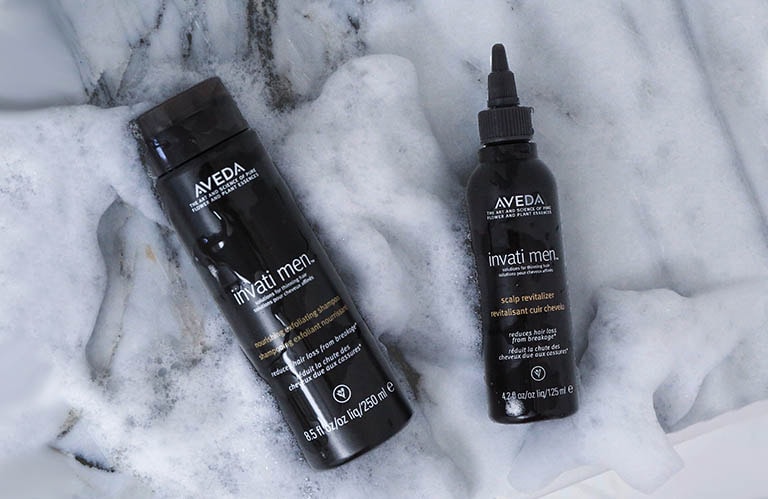 Client imagery of invati men™ nourishing exfoliating shampoo and invati men™ scalp revitalizer. 